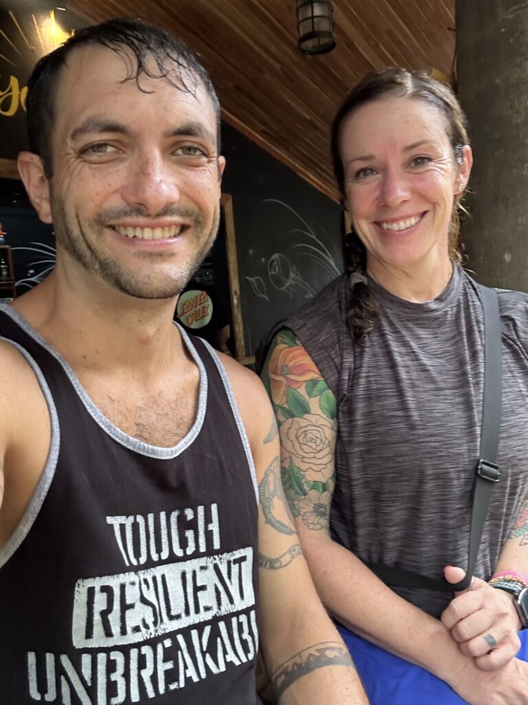 we are sitting in an open air jungle bar with wet hair and clothes