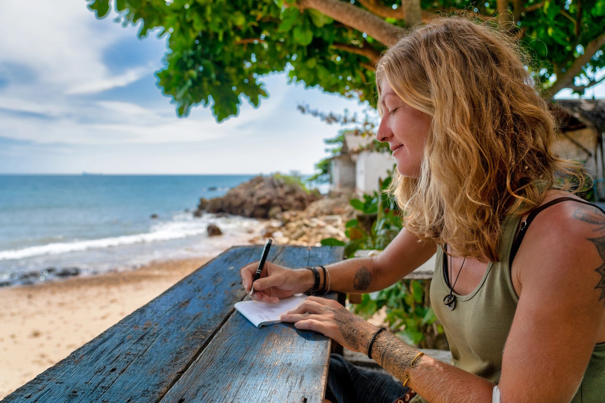 Woman journaling at the beach