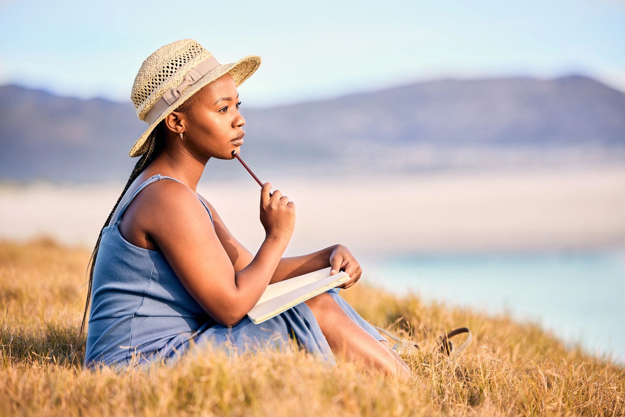 Woman journaling outdoors at sunrise