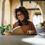 Smiling woman reading in a coffee shop