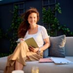 Businesswoman relaxing outdoors with a notebook