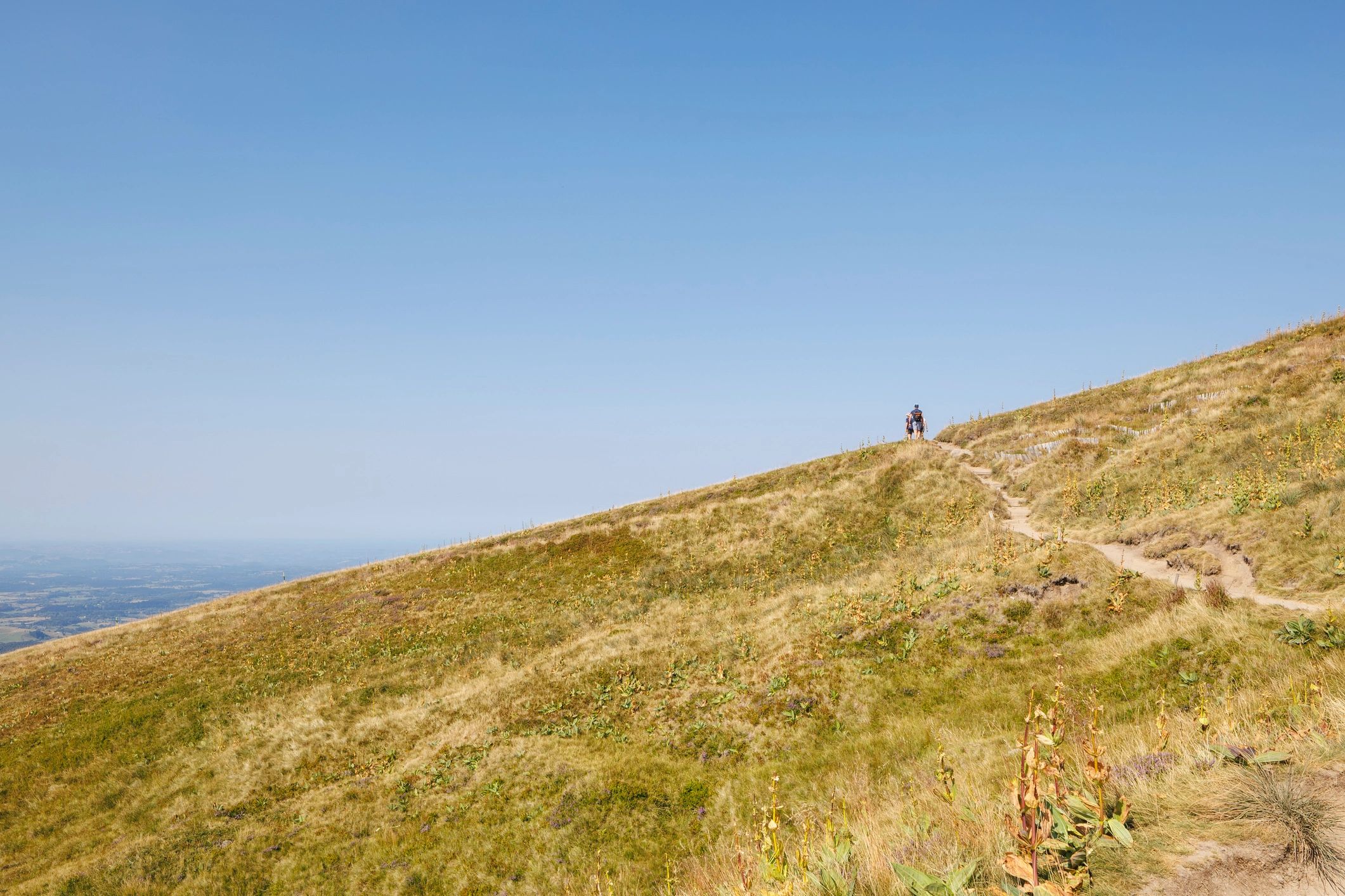 Hikers on a mountain ridge representing freedom and perspective