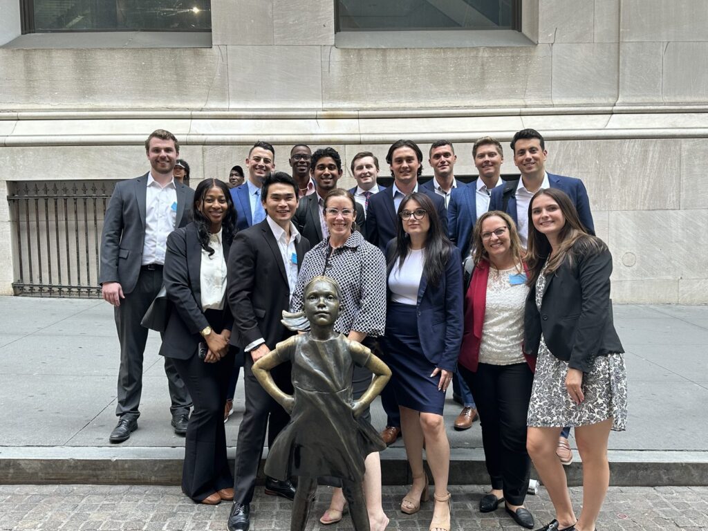 Amy with her former corporate team at the Fearless Girl statue