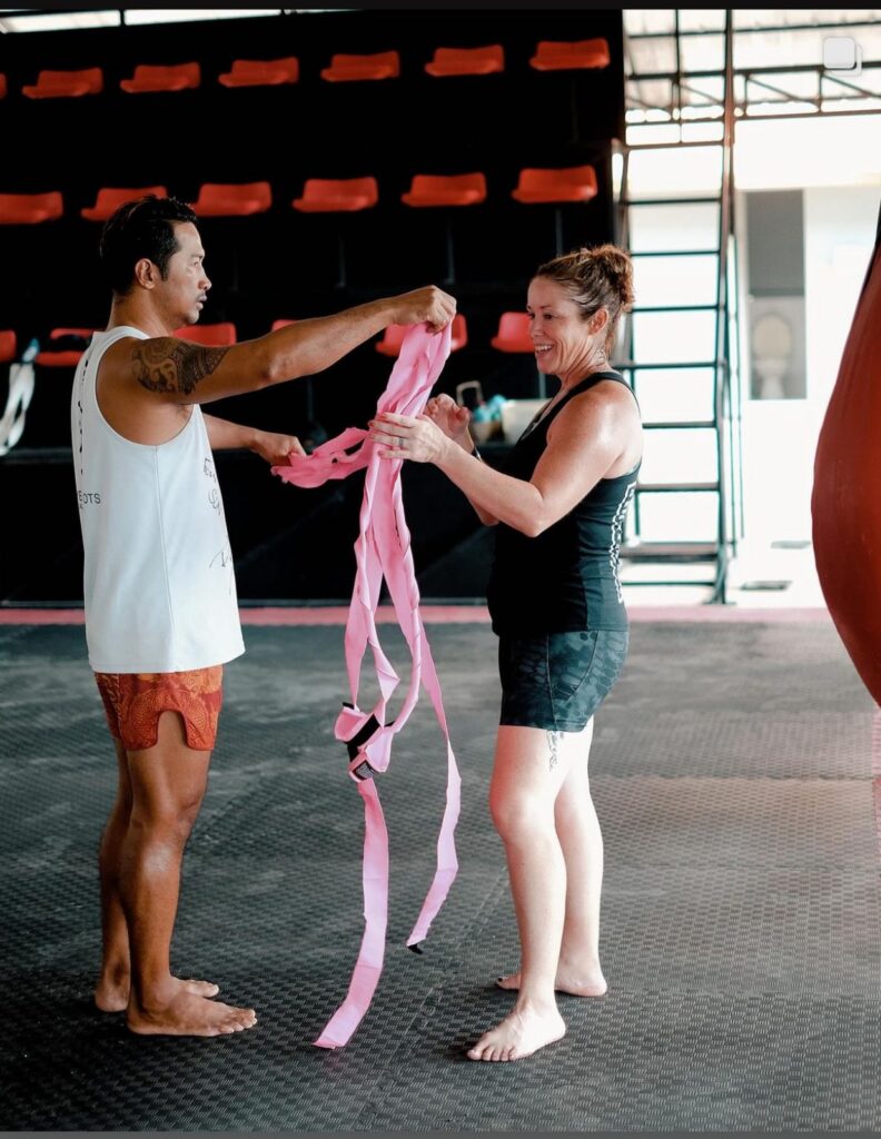 Amy getting her hands wrapped by a trainer before Muay Thai at Elite Fight Club in Hua Hin